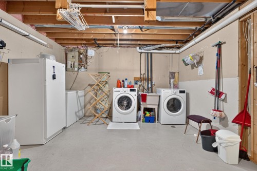 Dedicated laundry area featuring a utility sink, washing machine, and dryer - 31 Alpine Boulevard, St. Albert, AB 