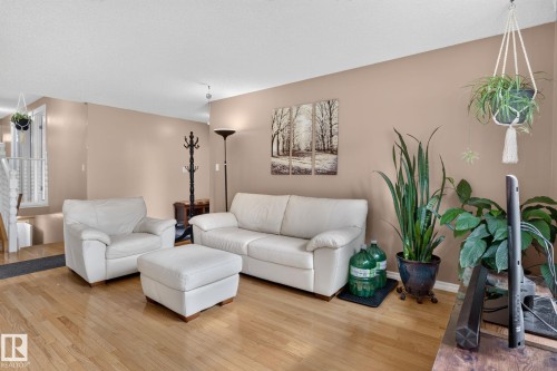 Hardwood flooring extends throughout this living space, complemented by neutral wall tones - 31 Alpine Boulevard, St. Albert, AB 