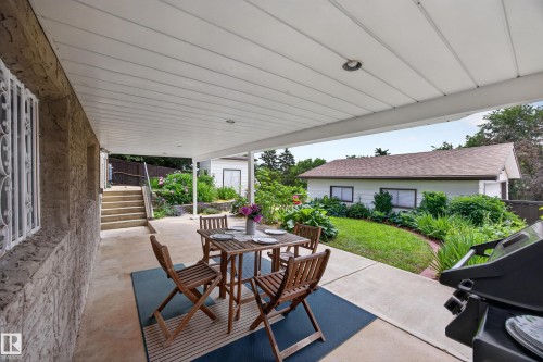 Covered concrete patio with recessed lighting, featuring an exterior wall with decorative security bars - 3411 103 Avenue, Edmonton, AB 