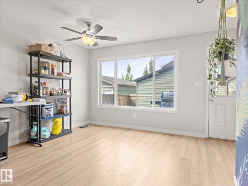 Light wood-finish flooring extending throughout the room - 473 Orchards Boulevard, Edmonton, AB 