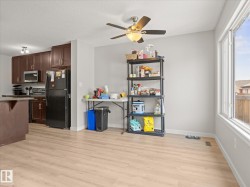 Open-concept living space with light wood-finish flooring - 