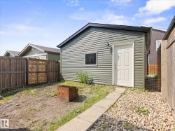 Detached ancillary building featuring horizontal siding and a dark shingled roof - 