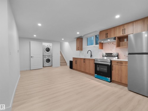 Open-concept living space with light wood-finish flooring - 320 38 Street, Edmonton, AB 