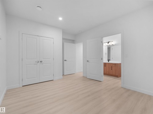 Bright room featuring light wood-finish flooring and recessed lighting - 320 38 Street, Edmonton, AB 