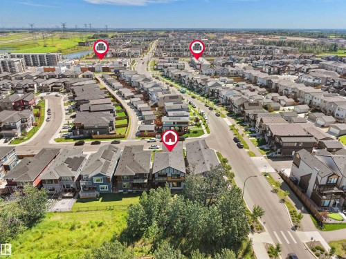 Aerial perspective showcasing a developed residential community with diverse modern architectural styles and mature street trees - 320 38 Street, Edmonton, AB 