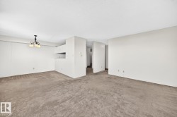 Spacious room featuring neutral carpet flooring and white walls - 