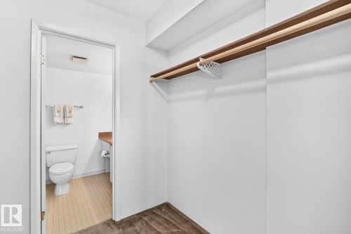 Spacious closet area featuring a built-in shelf and hanging rod - 806 10545 Saskatchewan Drive, Edmonton, AB 