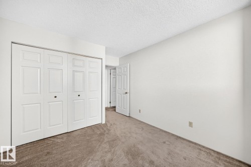 Bedroom featuring neutral-toned carpeting and light-colored walls - 806 10545 Saskatchewan Drive, Edmonton, AB 