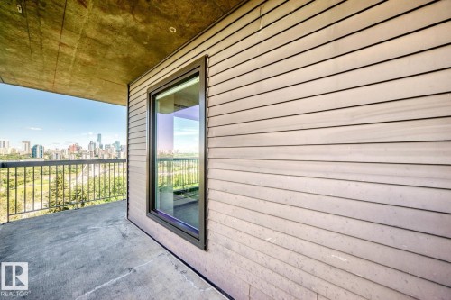 Private balcony with a concrete floor, a metal railing, and a window featuring a black frame - 806 10545 Saskatchewan Drive, Edmonton, AB 