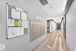 Entryway corridor featuring a built-in mailbox system, light-toned tiled flooring, and a neutral color palette - 