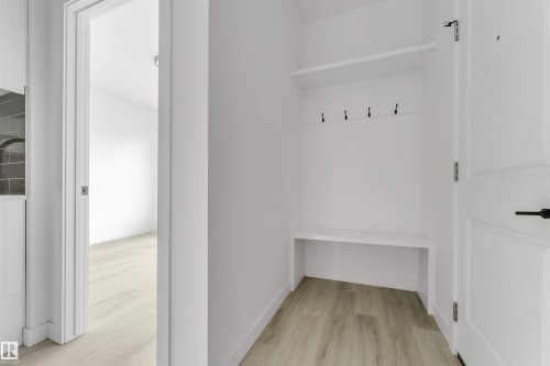 Built-in entryway bench with storage, upper shelf, and coat hooks - 3605 112 Ave, Edmonton, AB 