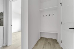 Built-in entryway bench with storage, upper shelf, and coat hooks - 
