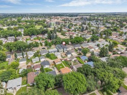 Residential neighborhood with established tree canopy and a mix of single-story and multi-story homes - 