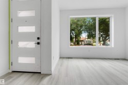 Entryway featuring a modern door with rectangular glass inserts and matte black hardware - 