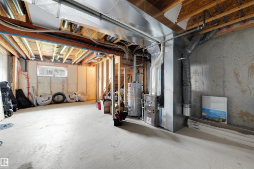 Unfinished basement featuring exposed wood joists, concrete flooring, and visible HVAC ductwork - #28 290 Spruce Ridge Rd, Spruce Grove, AB - Indoor Photo Showing Basement