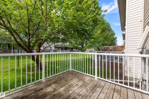 Exterior deck featuring wood-finish decking and white metal railings - #28 290 Spruce Ridge Rd, Spruce Grove, AB - Outdoor With Deck Patio Veranda