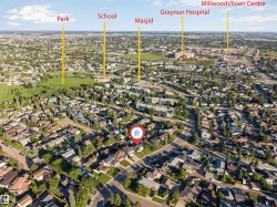 Aerial view of a residential neighborhood with surrounding green spaces and urban amenities - 