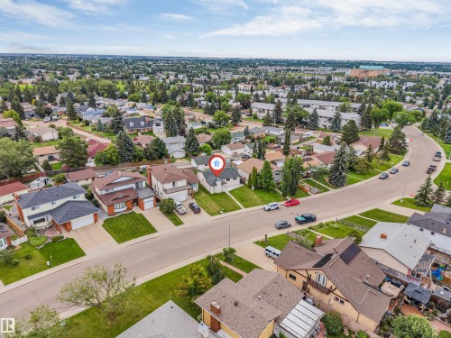 Expansive aerial perspective showcasing a residential neighborhood with mature trees and well-maintained properties - 193 Woodvale Road W, Edmonton, AB 