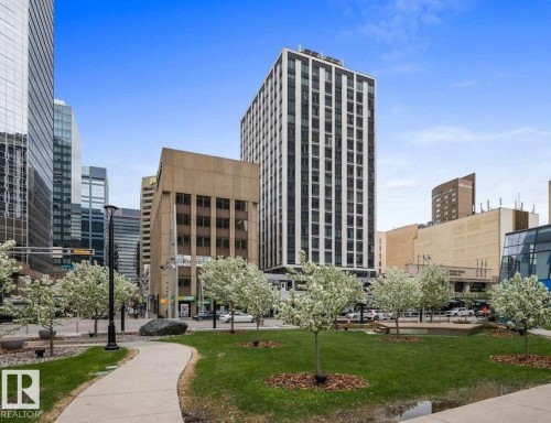 Urban park setting featuring a paved pathway, manicured green spaces, and mature trees - 206 10024 Jasper Avenue, Edmonton, AB 