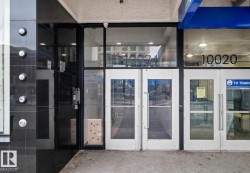 Commercial storefront featuring expansive glass panels and white-framed double-entry doors - 