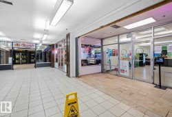Commercial corridor featuring recessed lighting and varied flooring surfaces - 