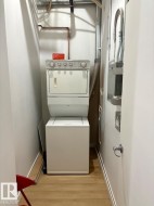 Dedicated laundry closet with wood-finish flooring - 