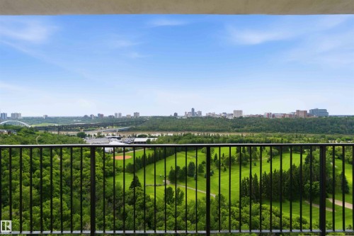 Expansive outdoor space featuring a dark metal railing, offering broad panoramas of a golf course, river, and distant cityscape - 1008 11307 99 Avenue, Edmonton, AB 