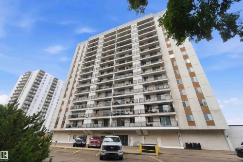 Mid-rise tower featuring multiple balconies, a white exterior, and brown accent panels - 1008 11307 99 Avenue, Edmonton, AB 