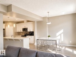 Open-concept kitchen and dining area featuring light wood-finish flooring - 