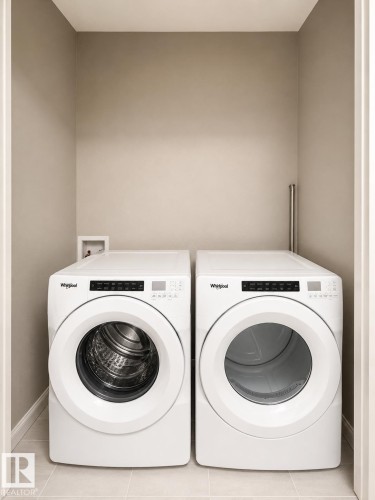 Dedicated laundry area featuring a front-loading washer and dryer set - 20104 19 Avenue, Edmonton, AB 