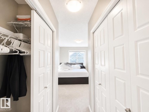 Hallway with neutral carpeting and light gray walls - 20104 19 Avenue, Edmonton, AB 