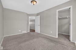 Neutral gray painted walls with white trim and gray carpeting - 