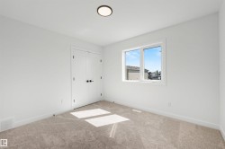 Room featuring neutral-toned carpeting and white walls with matching baseboards - 