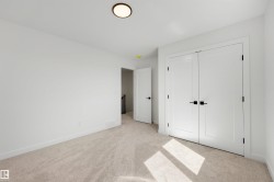 Neutral-toned carpet flooring complements the white walls and trim - 
