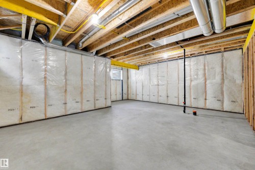 Unfinished basement with concrete flooring, framed and insulated walls, exposed ceiling joists, and visible ductwork - 30 Elsinore Place, Edmonton, AB 