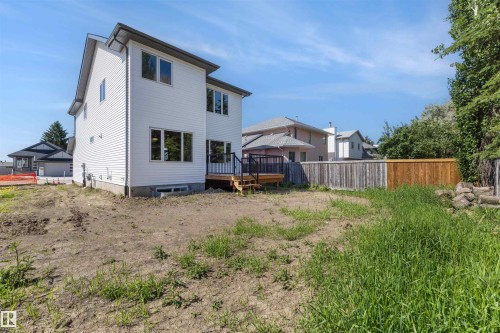 Rear exterior featuring white horizontal siding and a dark roofline - 30 Elsinore Place, Edmonton, AB 