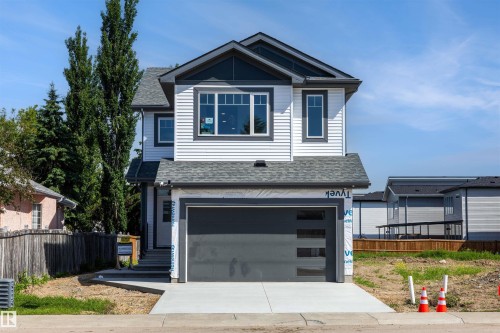 Contemporary two-story residence featuring white horizontal siding and dark gray trim - 30 Elsinore Place, Edmonton, AB 