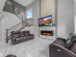Living area featuring high ceilings and large format tile flooring - 