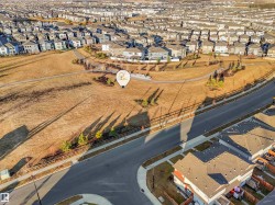 Expansive aerial perspective showcasing a residential development with numerous single-family homes - 