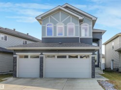 Contemporary two-story exterior featuring a two-tone facade with contrasting siding - 