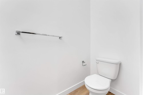 Contemporary powder room with clean white walls and wood-finish flooring - 1972 210 Street, Edmonton, AB 