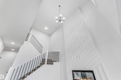 Two-story ceiling with recessed lighting and a contemporary chandelier - 1972 210 Street, Edmonton, AB 