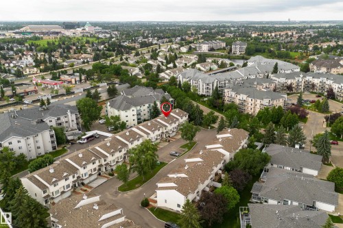 Aerial view showcasing a community of multi-story townhomes with dormer windows and established landscaping - 3 9703 174 Street, Edmonton, AB 