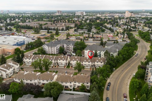 Townhouse property within a residential development, surrounded by mature trees and manicured green spaces - 3 9703 174 Street, Edmonton, AB 