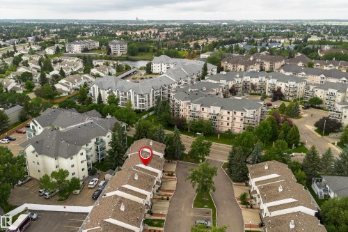 Aerial view of a residential community featuring townhomes and multi-story apartment buildings - 3 9703 174 Street, Edmonton, AB 