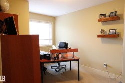Well-lit room with neutral-toned walls and carpet flooring - 