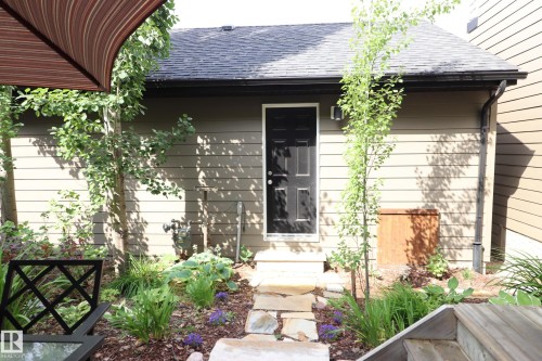 Rear structure with horizontal siding and dark trim - 7492 May Common, Edmonton, AB 