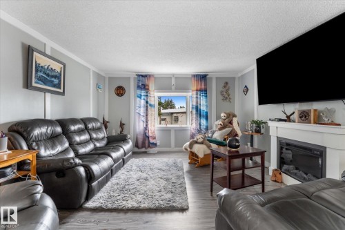 #9 305 Calahoo Rd, Spruce Grove, AB - Indoor Photo Showing Living Room With Fireplace