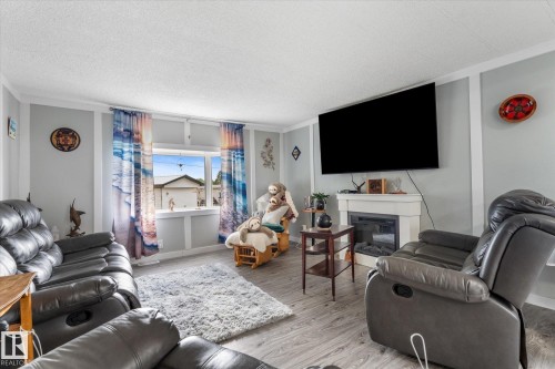 #9 305 Calahoo Rd, Spruce Grove, AB - Indoor Photo Showing Living Room With Fireplace