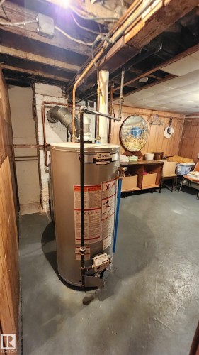 Water heater with exposed copper piping and visible ductwork - 9522 110 Avenue Nw, Edmonton, AB - Indoor Photo Showing Basement